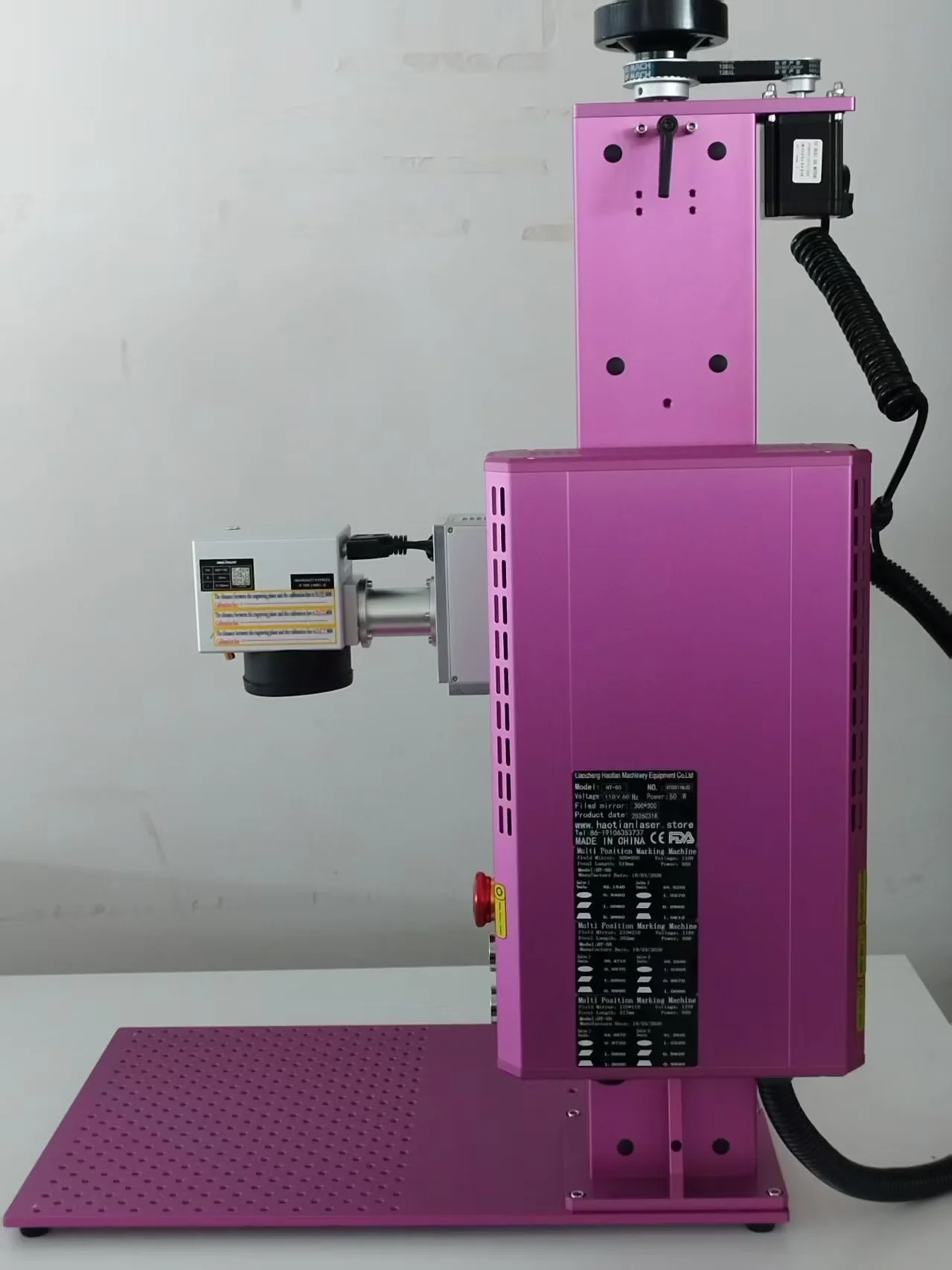Haotian 50W M8 fiber laser in custom pink showing specification label and galvo head
