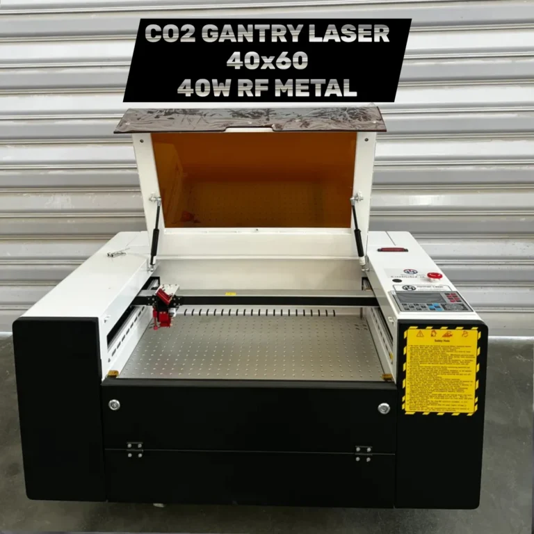 Industrial CO2 Gantry laser machine for engraving and cutting, featuring a 40x60 cm work area and a 40W RF metal laser tube. The device is shown in a white and black chassis with the protective orange-tinted lid open, revealing the honeycomb workbed and laser head.