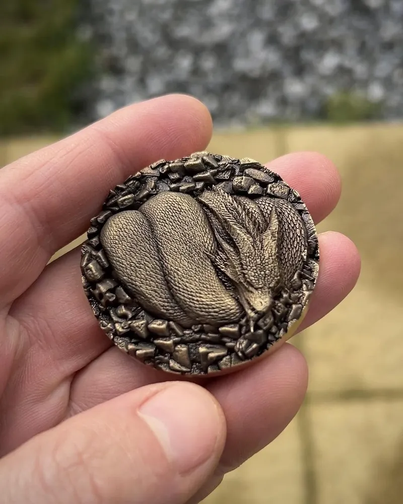 Bronze coin with 3D relief sleeping dragon, jewellery grade engraving made on a JPT MOPA fiber laser