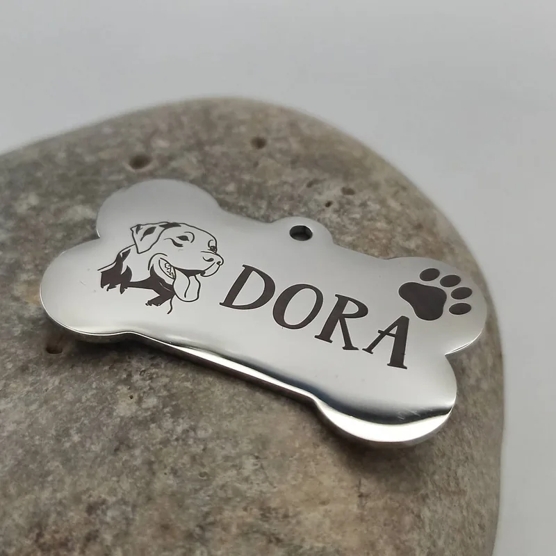 Custom pet ID tag for a dog named Dora engraved on a fiber laser
