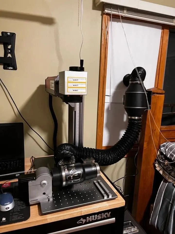Haotian fiber laser with rotary attachment engraving a tumbler in a customer home