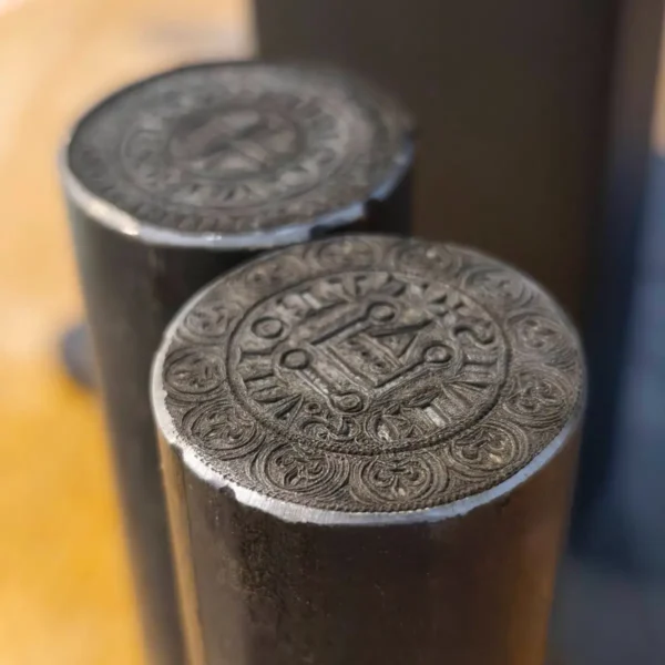 Steel coin dies deep engraved with a 60W fiber laser for metal engraving