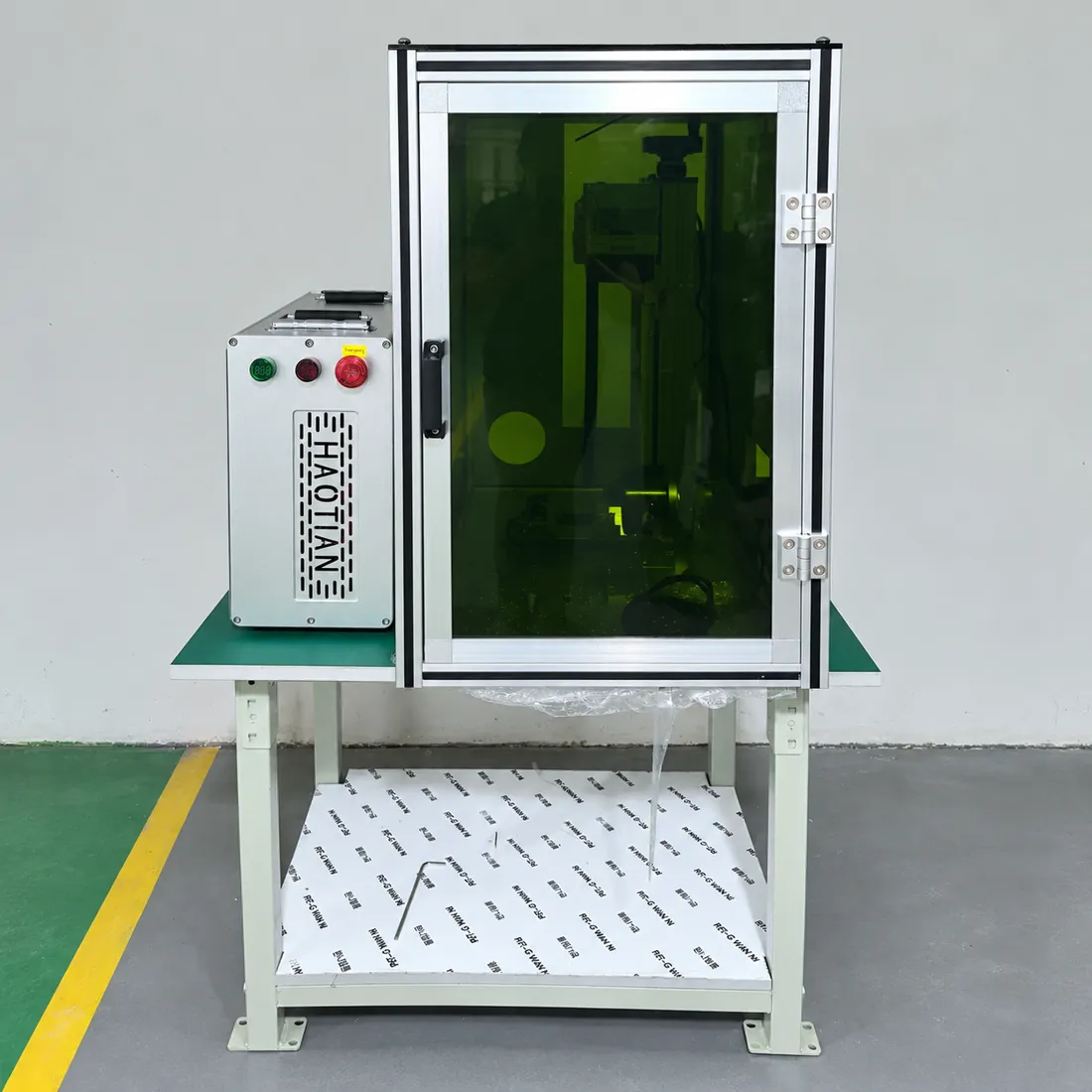 Haotian fiber laser with laser safety enclosure on a workstation table