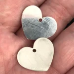 Two heart pendants with hanging holes cut from 0.8 mm and 1 mm 925 sterling silver with a 200W JPT M7 MOPA fiber laser