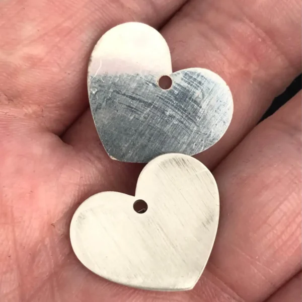 Two heart pendants with hanging holes cut from 0.8 mm and 1 mm 925 sterling silver with a 200W JPT M7 MOPA fiber laser