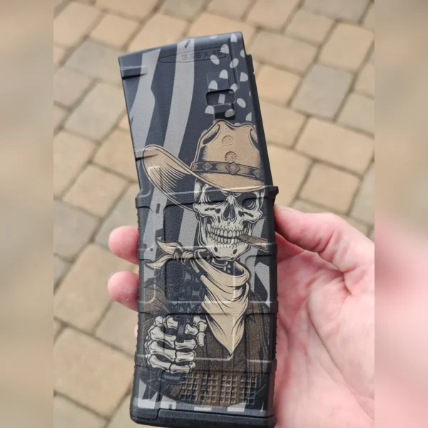 Polymer magazine engraved with a cowboy skull and flag background using 60W JPT EM7 MOPA fiber laser