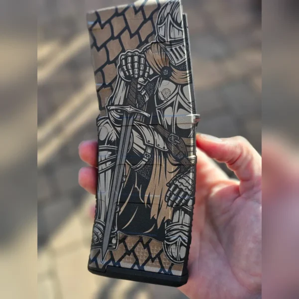 Polymer rifle magazine engraved with a medieval knight and stone wall design using 60W JPT EM7 MOPA fiber laser