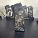 Polymer magazine engraved with a detailed sea god and trident illustration using 60W JPT EM7 MOPA fiber laser