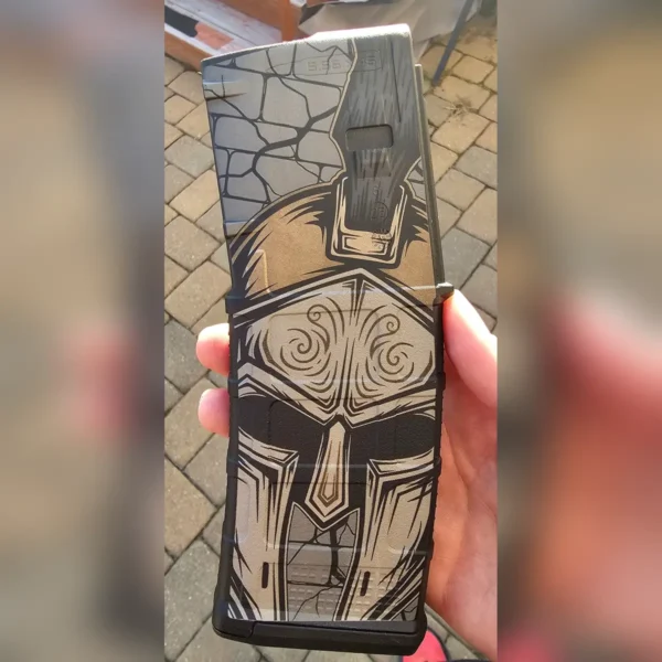 Polymer magazine engraved with a Spartan helmet in tan and grey tones using 60W JPT EM7 MOPA fiber laser