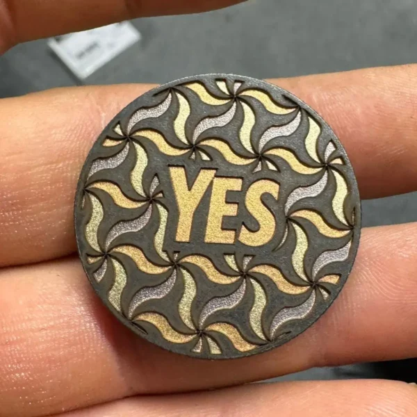 Steel coin with gold and silver colour marking made with 100W JPT M7 MOPA fiber laser