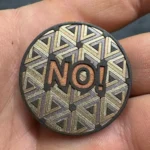 Colour marked steel token with geometric pattern made with 100W JPT M7 MOPA fiber laser