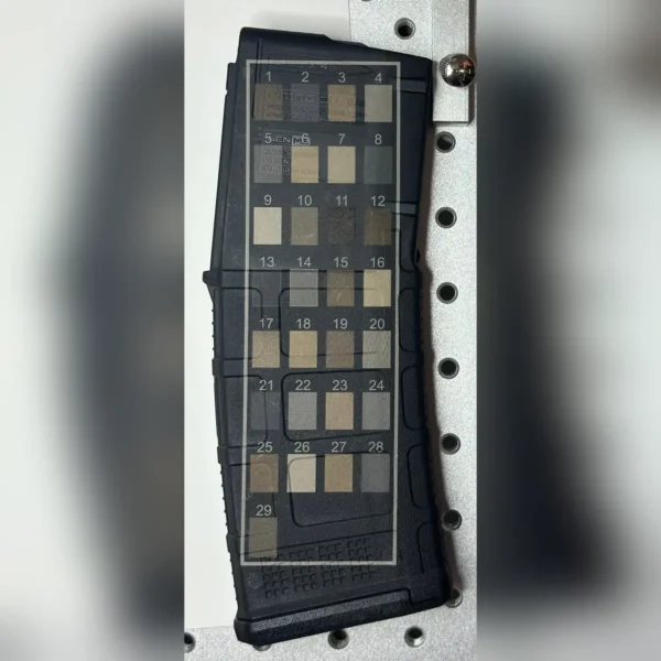 Test grid of 29 laser settings showing different shades on a black polymer magazine, made with 60W JPT EM7 MOPA fiber laser